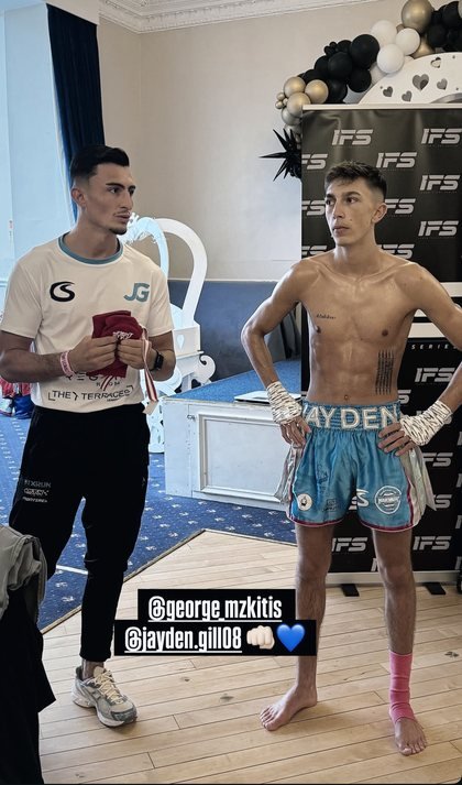 Jayden Gill backstage with his coach before a fight
