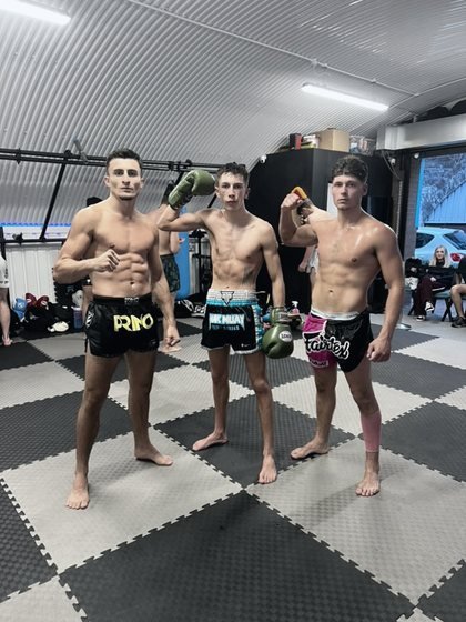 Jayden Gill with two training partners on the mats at Nak Muay Gym