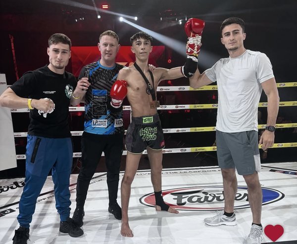 Jayden Gill having his hand raised with his corner at Leapfrog Fight Night